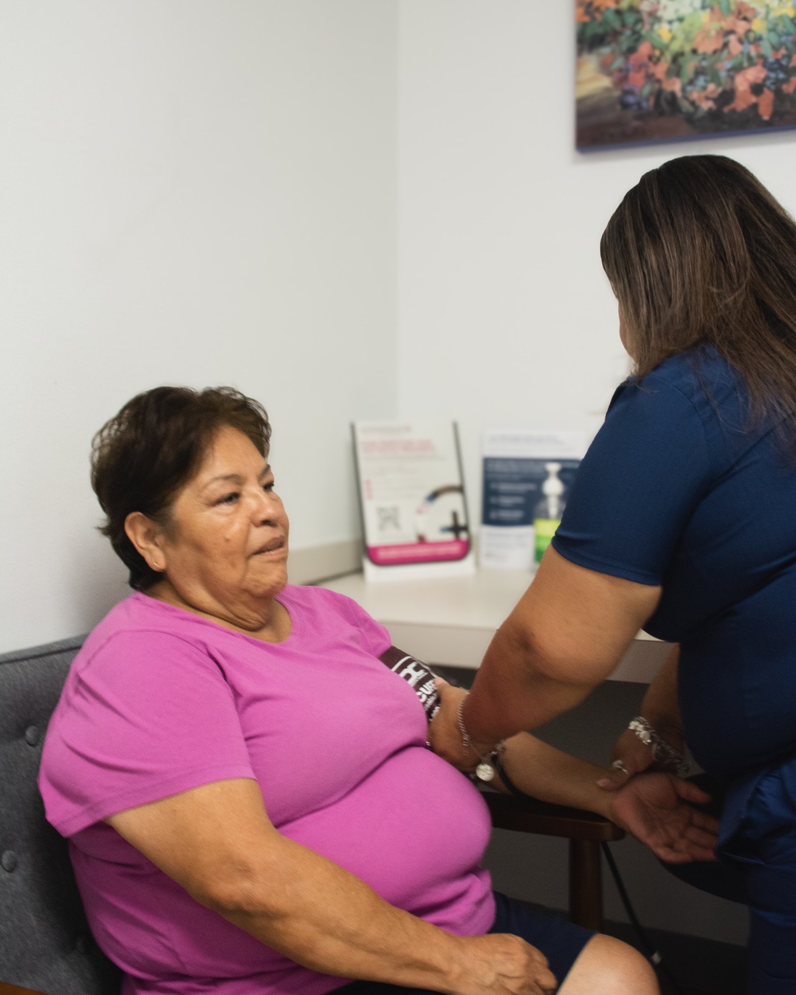 Healthcare professional checking a patient’s blood pressure during a primary care visit